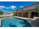 Backyard featuring a refreshing pool with a tanning ledge and a covered patio, perfect for entertaining at 16018 N 17Th Way, Phoenix, AZ 85022