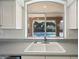 Kitchen sink with a view of the pool and covered outdoor seating area at 16018 N 17Th Way, Phoenix, AZ 85022