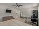 Main bedroom with a ceiling fan, a desk, and carpet at 16610 W Culver St, Goodyear, AZ 85338