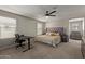 Spacious main bedroom with a ceiling fan and large windows at 16610 W Culver St, Goodyear, AZ 85338