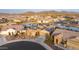 Aerial view of neighborhood with lake, desert landscaping and mountain views at 16683 S 180Th Dr, Goodyear, AZ 85338