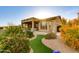 Lush landscaping and manicured artificial turf highlight the beauty of this home's outdoor living space at 16683 S 180Th Dr, Goodyear, AZ 85338