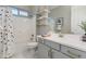 Stylish bathroom with neutral-colored cabinets, and sleek fixtures, including a shower and tub combo at 16683 S 180Th Dr, Goodyear, AZ 85338