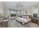 Bedroom featuring a large window with curtains, neutral decor, ceiling fan, and a neighborhood view at 16683 S 180Th Dr, Goodyear, AZ 85338