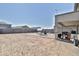 Wide backyard view featuring a brick patio with a swing, perfect for outdoor relaxation and entertainment at 16873 W Fetlock Trl, Surprise, AZ 85387