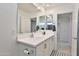 Bright bathroom with a double sink vanity, large mirror, and modern fixtures at 16873 W Fetlock Trl, Surprise, AZ 85387