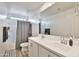 Clean bathroom with double sinks, modern vanity, and a shower-tub combination at 16873 W Fetlock Trl, Surprise, AZ 85387