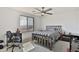 Comfortable bedroom featuring a ceiling fan, and a window with natural light at 16873 W Fetlock Trl, Surprise, AZ 85387