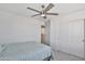Inviting bedroom with a ceiling fan, closet, and neutral carpet at 16873 W Fetlock Trl, Surprise, AZ 85387