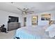 Bedroom with a ceiling fan and TV at 16873 W Fetlock Trl, Surprise, AZ 85387