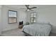 Cozy bedroom with a comfortable bed, ceiling fan, and natural light at 16873 W Fetlock Trl, Surprise, AZ 85387