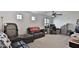 Large bonus room with natural light, ceiling fan, and comfortable seating at 16873 W Fetlock Trl, Surprise, AZ 85387