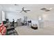 Bright bonus room featuring a ceiling fan, neutral carpet, and plenty of open space at 16873 W Fetlock Trl, Surprise, AZ 85387