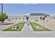 Community area with artificial grass, benches, and a horseshoe setup at 16873 W Fetlock Trl, Surprise, AZ 85387