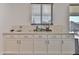 Kitchen featuring white cabinets, modern hardware, and ample counter space at 16873 W Fetlock Trl, Surprise, AZ 85387