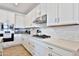 Bright kitchen featuring white cabinetry, stainless steel appliances, and light countertops at 16873 W Fetlock Trl, Surprise, AZ 85387