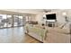 Inviting living room with wood-look flooring, a large sofa, dining area, and sliding glass doors to the backyard at 16873 W Fetlock Trl, Surprise, AZ 85387