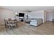 Spacious living room with wood-look flooring, comfortable seating, a ceiling fan, and ample natural light at 16873 W Fetlock Trl, Surprise, AZ 85387
