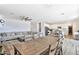 Open-concept living area with a large sofa, dining table, and bright natural light at 16873 W Fetlock Trl, Surprise, AZ 85387