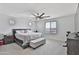 Serene primary bedroom with soft carpet, neutral decor, and a ceiling fan at 16873 W Fetlock Trl, Surprise, AZ 85387