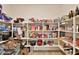 Walk-in pantry with ample storage shelves and organized food items at 16873 W Fetlock Trl, Surprise, AZ 85387