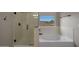 Bathroom with a standalone tub and a walk-in shower at 18039 W Sunnyslope Ln, Waddell, AZ 85355