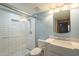 This bathroom is updated with a glass enclosed shower, white subway tile, and blue accent wall at 18194 N 59Th Ln, Glendale, AZ 85308