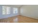 Bright bedroom featuring laminate flooring, and large windows creating a serene atmosphere at 18194 N 59Th Ln, Glendale, AZ 85308