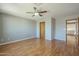 Well-lit bedroom with hardwood floors, a ceiling fan and hallway entrance at 18194 N 59Th Ln, Glendale, AZ 85308