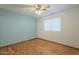 The bedroom is simply staged with light blue paint and wood floors at 18194 N 59Th Ln, Glendale, AZ 85308