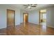 Hardwood floored bedroom featuring a ceiling fan, and bathroom entrance at 18194 N 59Th Ln, Glendale, AZ 85308