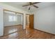 A bedroom featuring wood-look floors, a ceiling fan and closet with mirrored doors at 18194 N 59Th Ln, Glendale, AZ 85308
