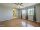 Large bedroom with hardwood floors, ceiling fan, and natural light at 18194 N 59Th Ln, Glendale, AZ 85308