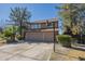 Two-story home featuring a two-car garage, basketball hoop and low maintenance landscaping at 18194 N 59Th Ln, Glendale, AZ 85308