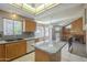 Well-lit kitchen offering stainless steel appliances, tile backsplash, granite counters, and spacious center island at 18194 N 59Th Ln, Glendale, AZ 85308