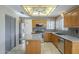 Spacious kitchen featuring stainless steel appliances, island, and tile floors at 18194 N 59Th Ln, Glendale, AZ 85308