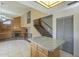 This kitchen flows into living space with island, tile floor, bright lighting, and neutral colors at 18194 N 59Th Ln, Glendale, AZ 85308