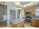 Well-equipped kitchen features stainless steel appliances, a kitchen island, ample cabinetry, and tile flooring at 18194 N 59Th Ln, Glendale, AZ 85308