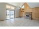Spacious living room with tile flooring, fireplace, ceiling fan, and sliding glass door to patio at 18194 N 59Th Ln, Glendale, AZ 85308