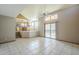 Bright living area boasts an open floor plan, tile floors, and glass sliding door that leads to patio at 18194 N 59Th Ln, Glendale, AZ 85308