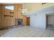 Living room featuring a brick fireplace, wood paneling, high ceilings, and tile flooring at 18194 N 59Th Ln, Glendale, AZ 85308