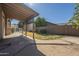 Covered patio overlooks a well-maintained backyard with a swimming pool at 18194 N 59Th Ln, Glendale, AZ 85308