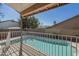 Covered patio offers view of a fenced in pool and neighboring houses at 18194 N 59Th Ln, Glendale, AZ 85308