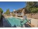 Home's private backyard pool featuring a basketball hoop and desert landscaping at 18194 N 59Th Ln, Glendale, AZ 85308