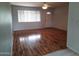 Bright living room with new wood floors, ceiling fan, and an entry door at 18221 N 56Th Ln, Glendale, AZ 85308