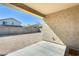 Covered patio provides shade over the large, undeveloped backyard with block wall at 19685 W Roma Ave, Litchfield Park, AZ 85340