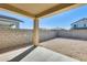 Covered patio overlooking a large backyard with block wall for added privacy at 19685 W Roma Ave, Litchfield Park, AZ 85340