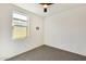 Bedroom with neutral carpet, white walls, and a ceiling fan at 19685 W Roma Ave, Litchfield Park, AZ 85340