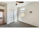 This carpeted bedroom has a ceiling fan, closet and nice natural light at 19685 W Roma Ave, Litchfield Park, AZ 85340