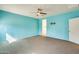 Large bedroom with gray carpeting, a ceiling fan, and wall mount for a TV at 19685 W Roma Ave, Litchfield Park, AZ 85340